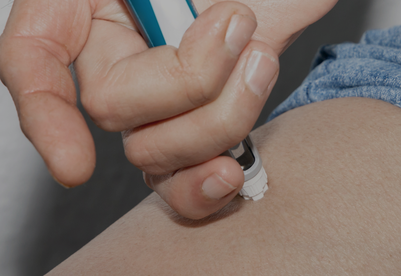 Woman injecting weight loss medication in her leg